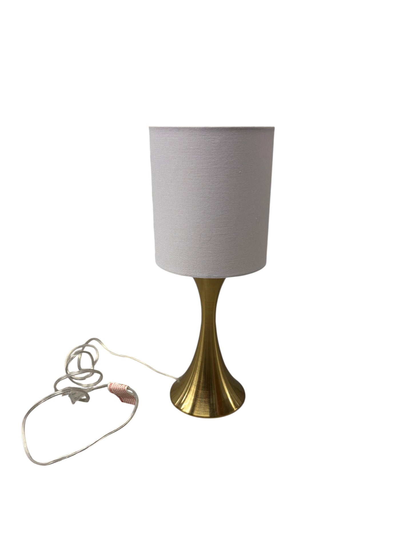 Gold lamp with a white shade and cord.