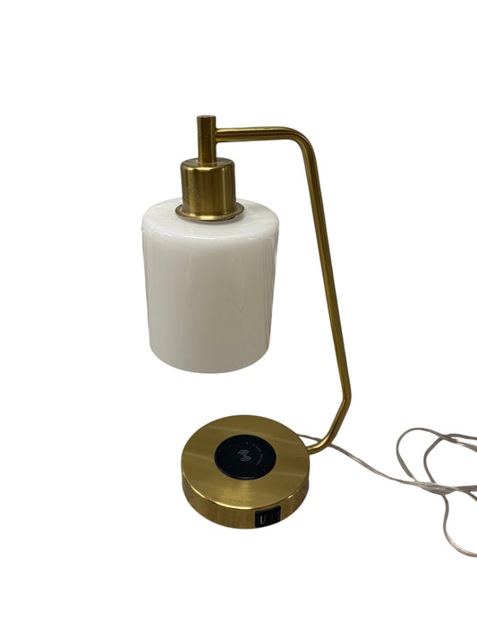 Gold desk or bedside table lamp with charging port in the base and opal glass shade.