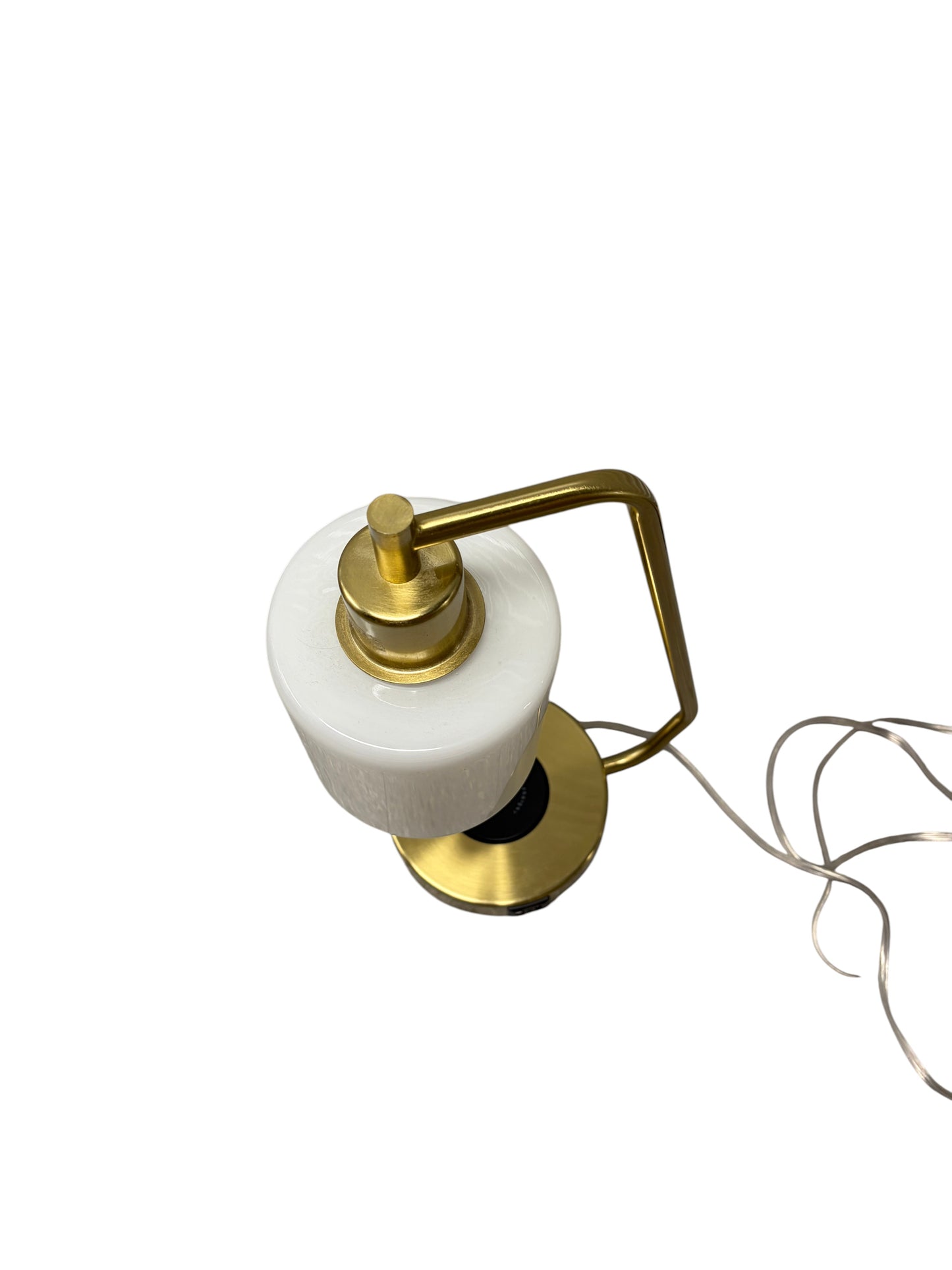 Gold desk or bedside table lamp with charging port in the base and opal glass shade.