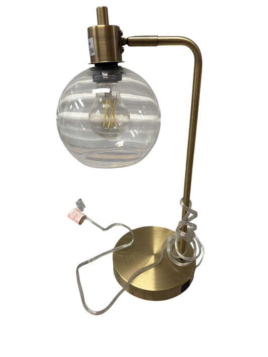Gold desk lamp with clear glass shade and USB charging port.