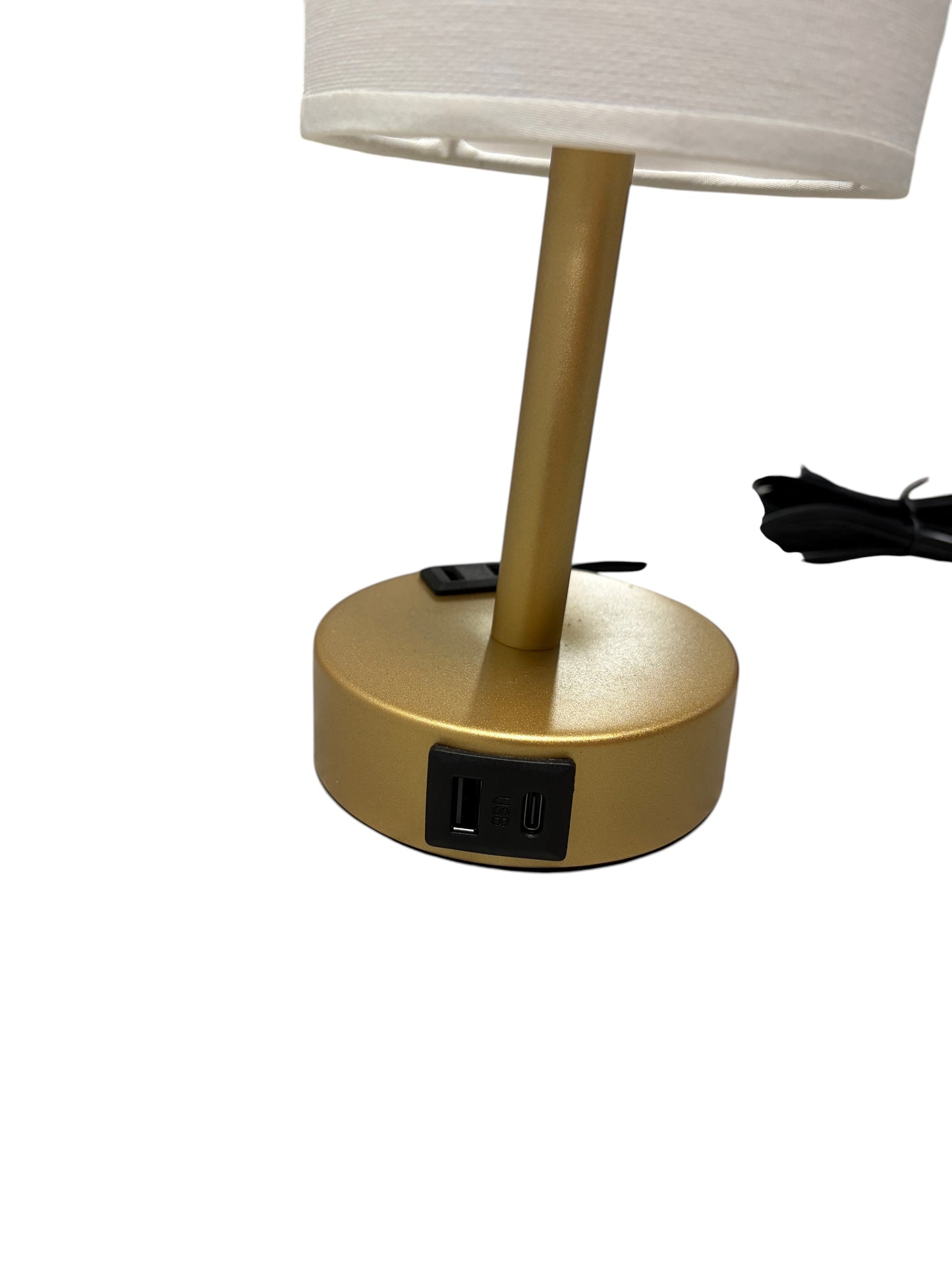 Gold lamp with a cream shade and built-in charging ports.