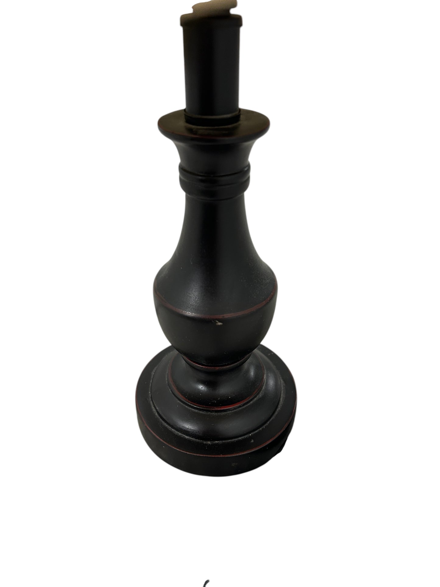A table lamp with a black ceramic base and beige linen shade.