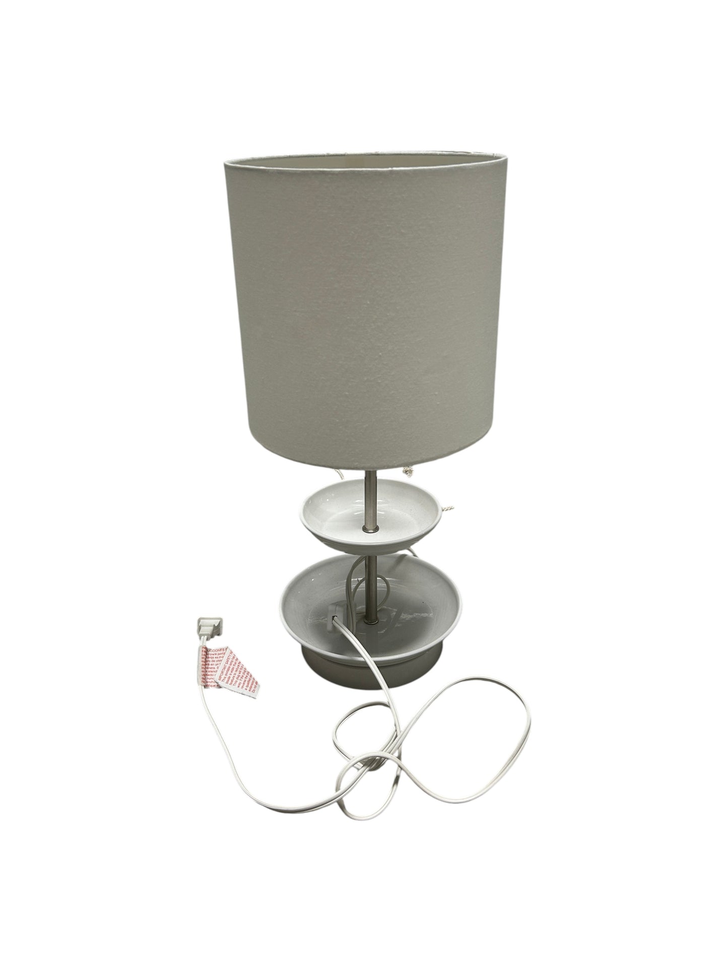 A white cylindrical table lamp.
