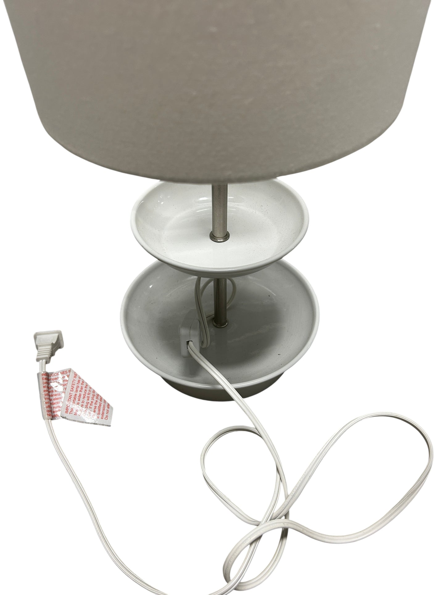A white cylindrical table lamp.