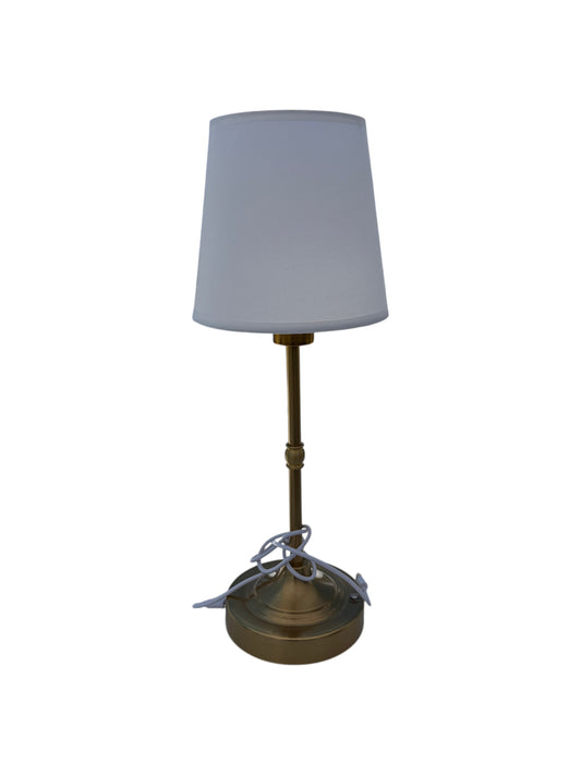 Gold table lamp with white shade.