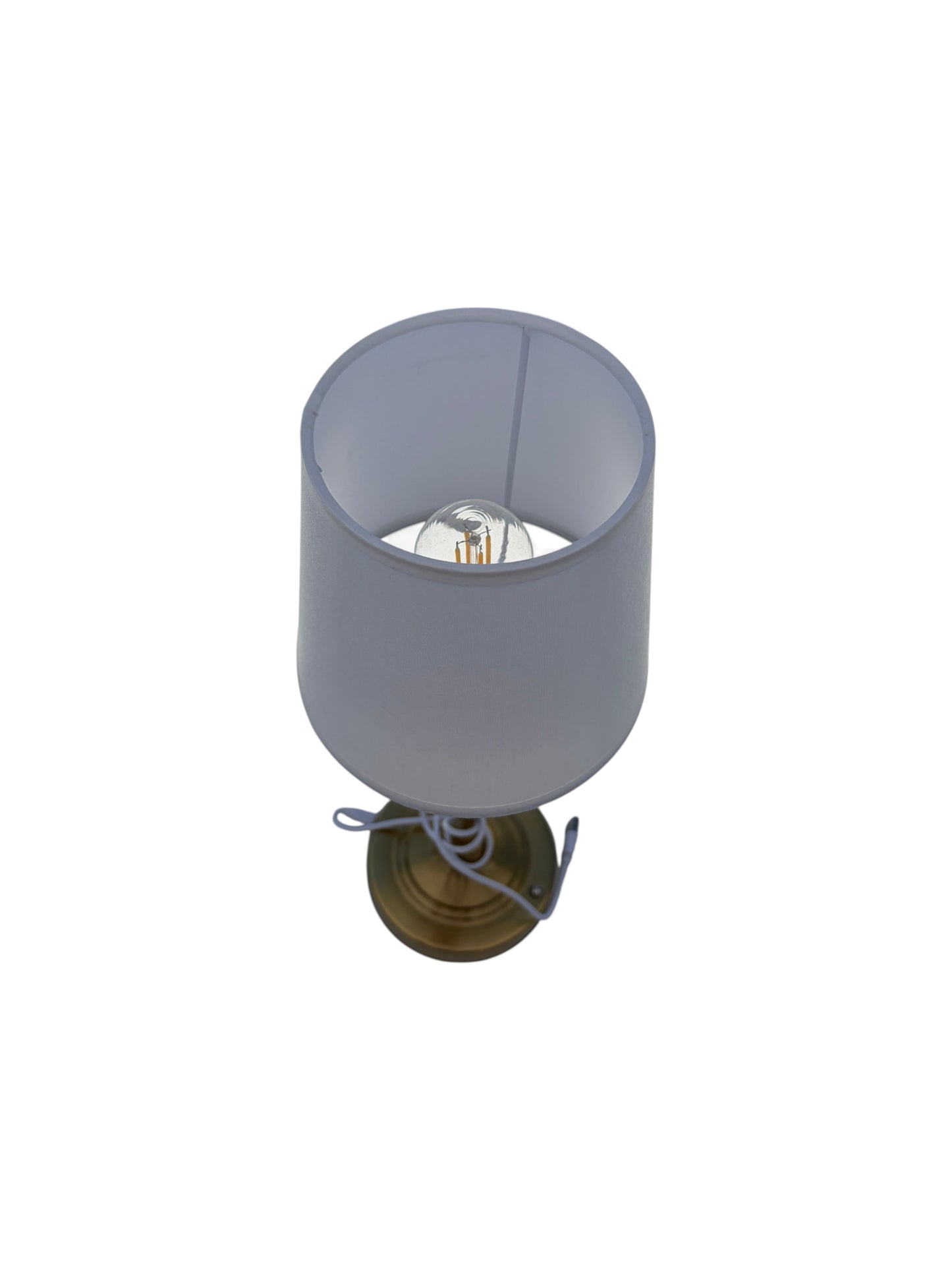 Gold table lamp with white shade.