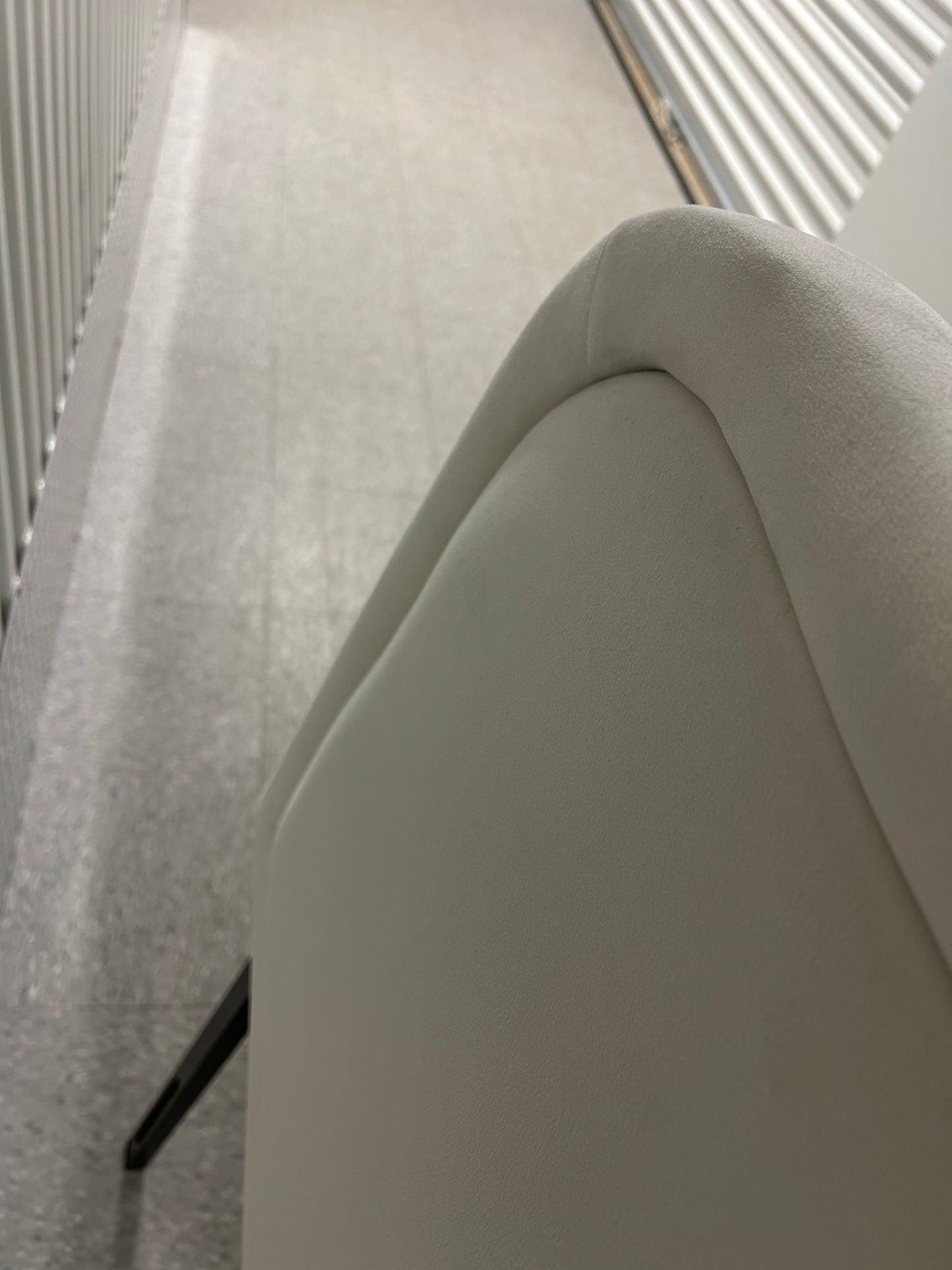 White queen velvet headboard with black metal legs.