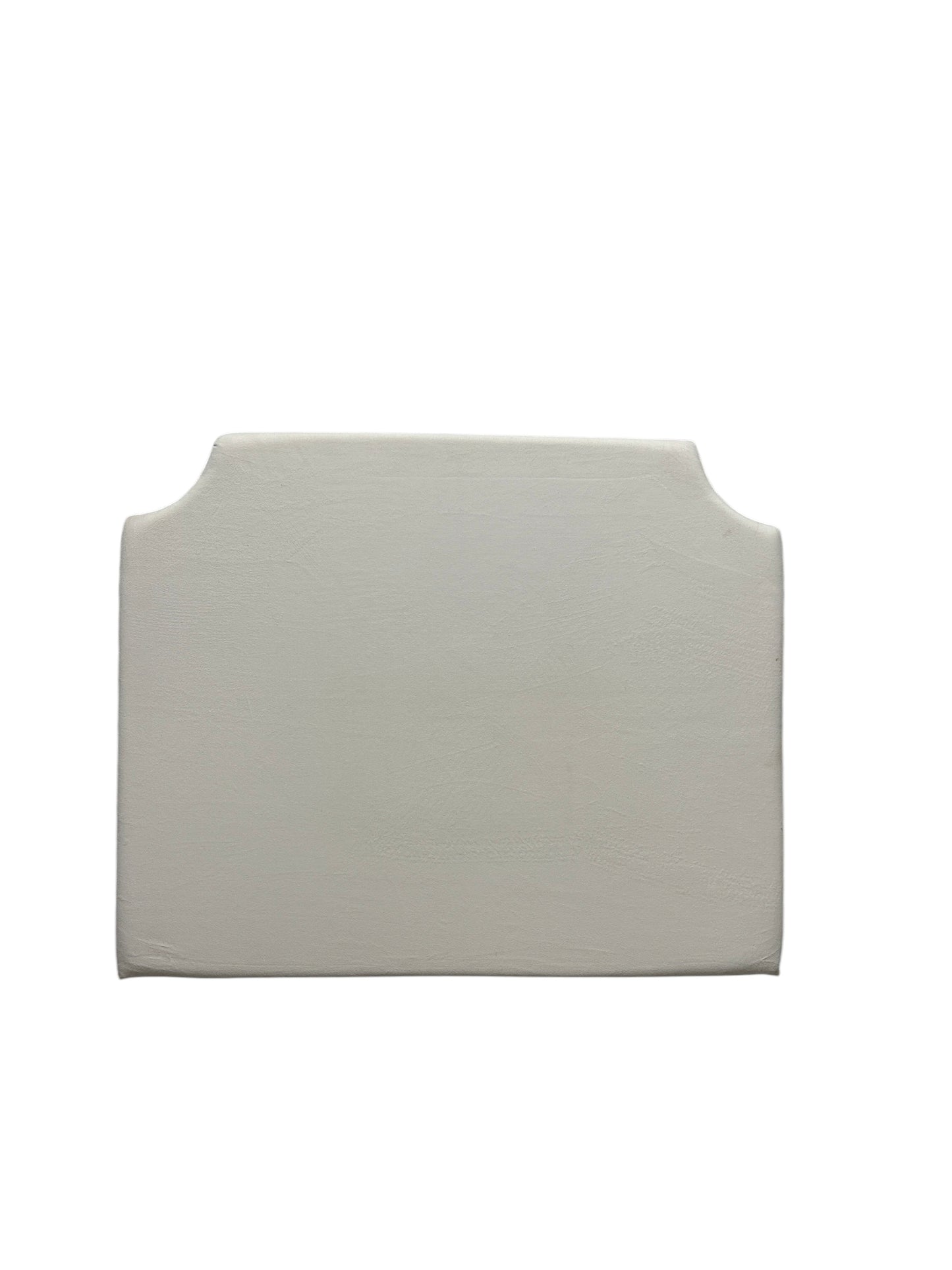 Cream velvet twin headboard with curved notched corners.