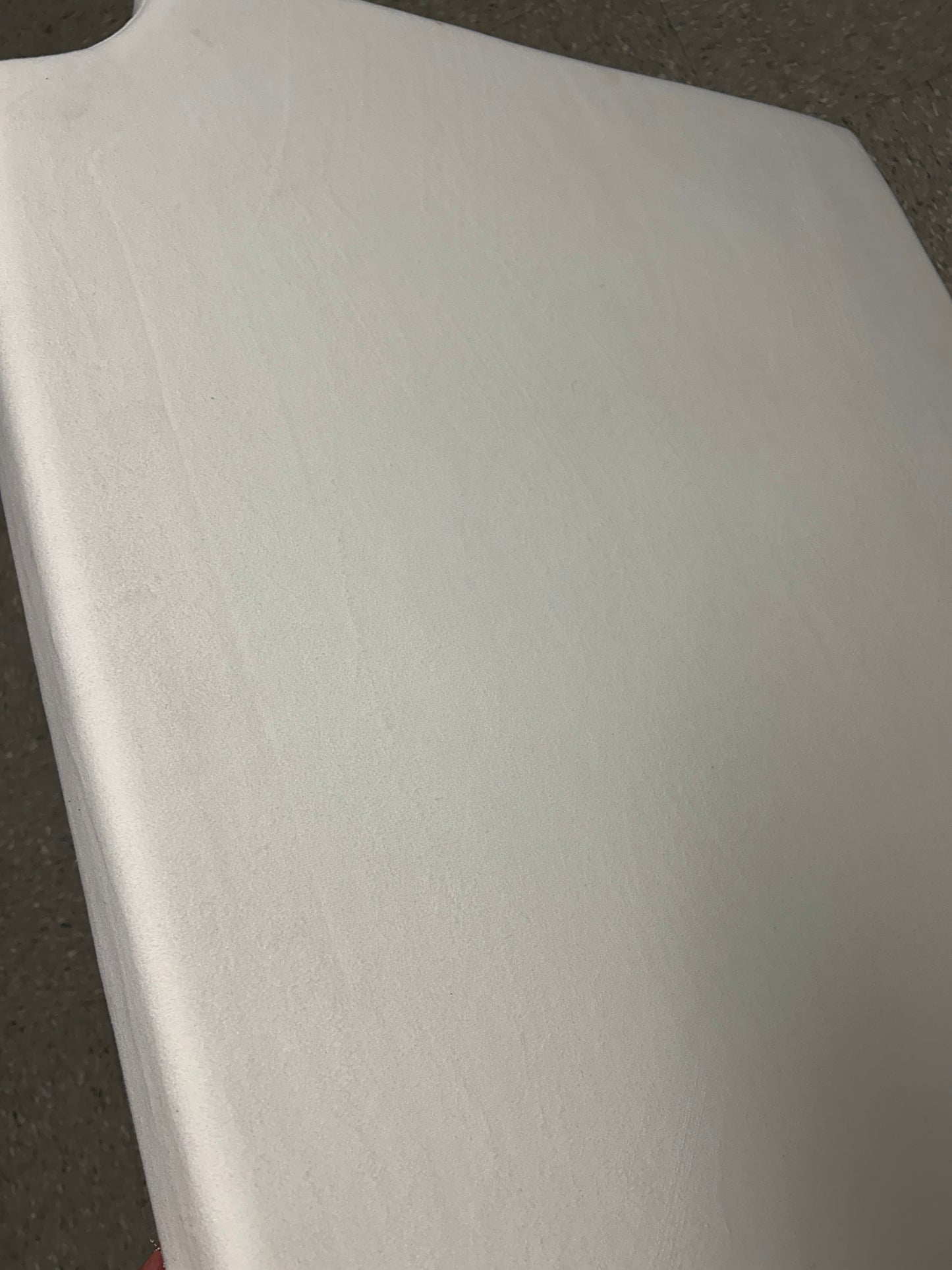Cream velvet twin headboard with curved notched corners.