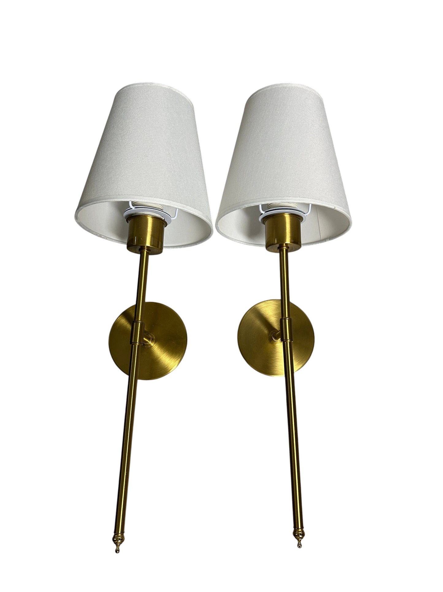 Pair of gold wall sconces with white shades.