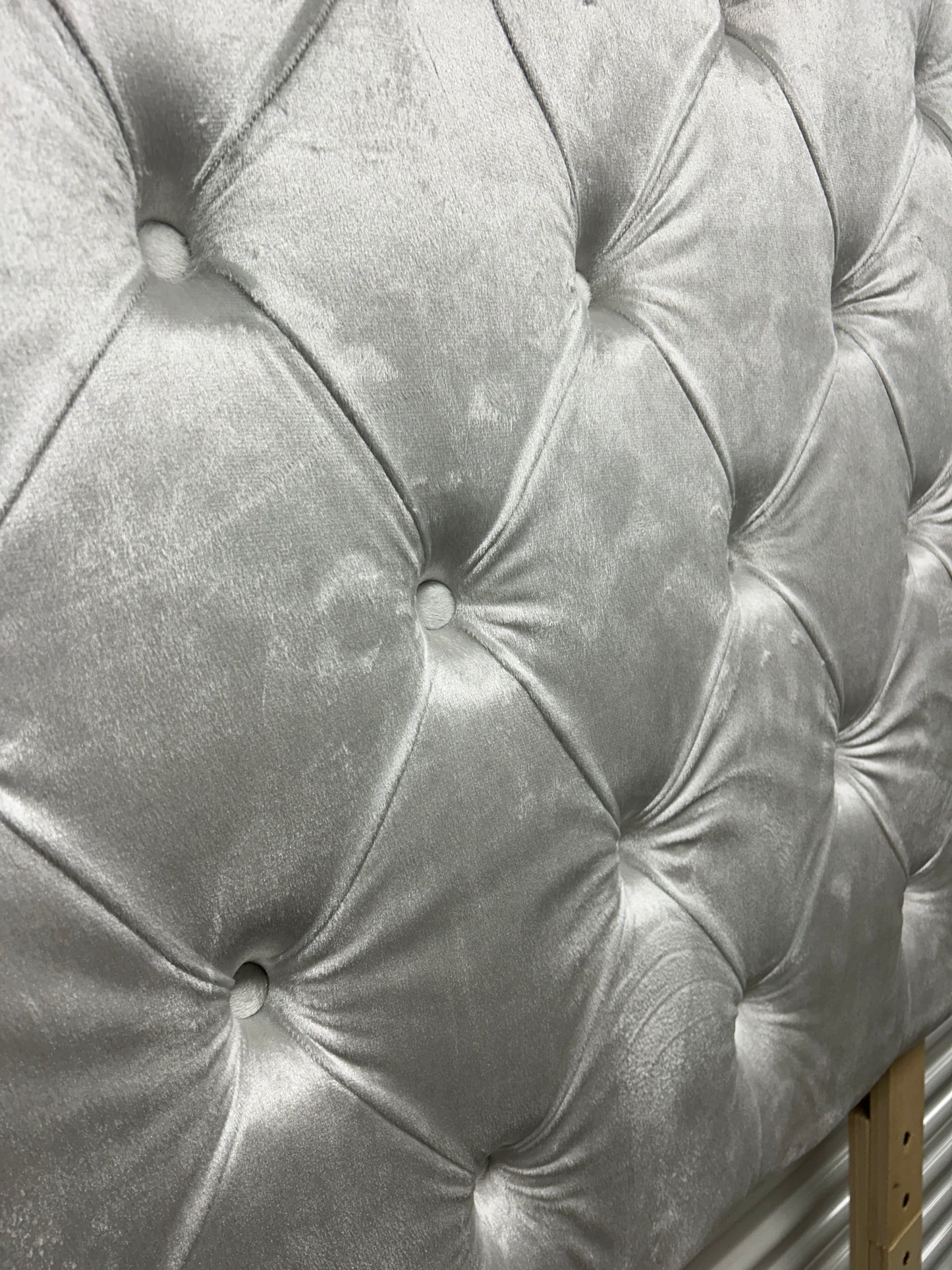 Silver twin velvet headboard with wooden legs.