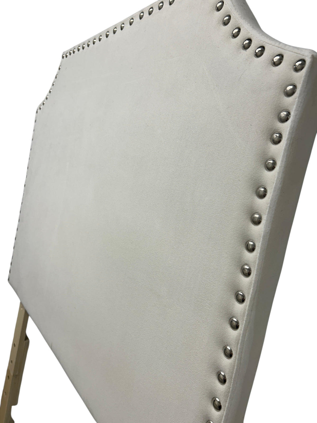 White velvet twin headboard with silver buttons and wooden legs.