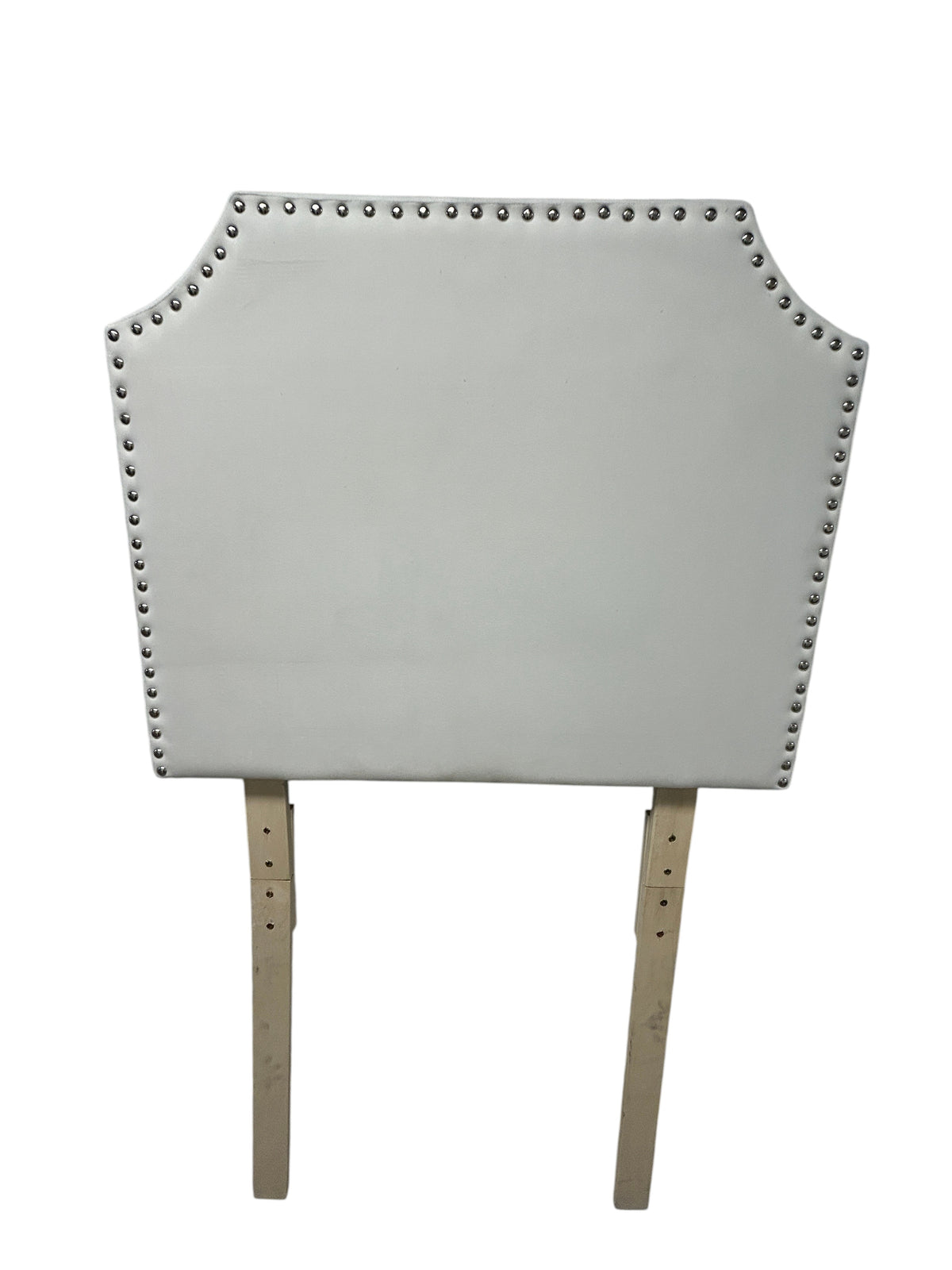 White velvet twin headboard with silver buttons and wooden legs.