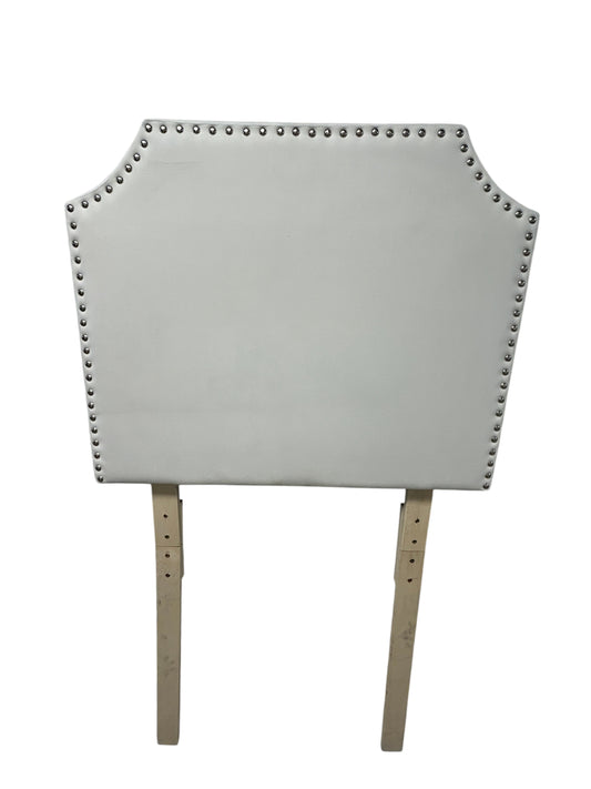 White velvet twin headboard with silver buttons and wooden legs.