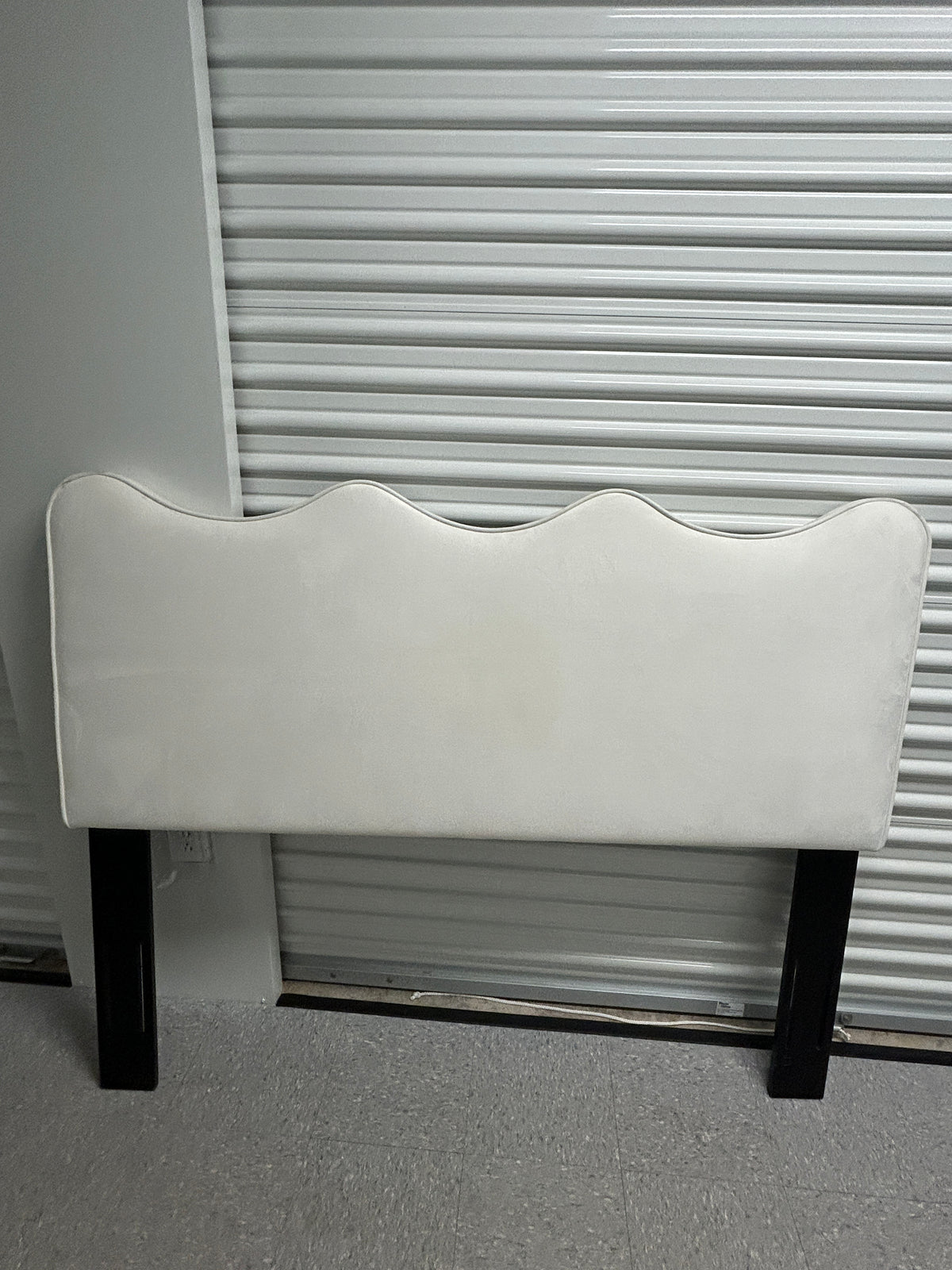 Off-white queen velvet headboard with black legs.