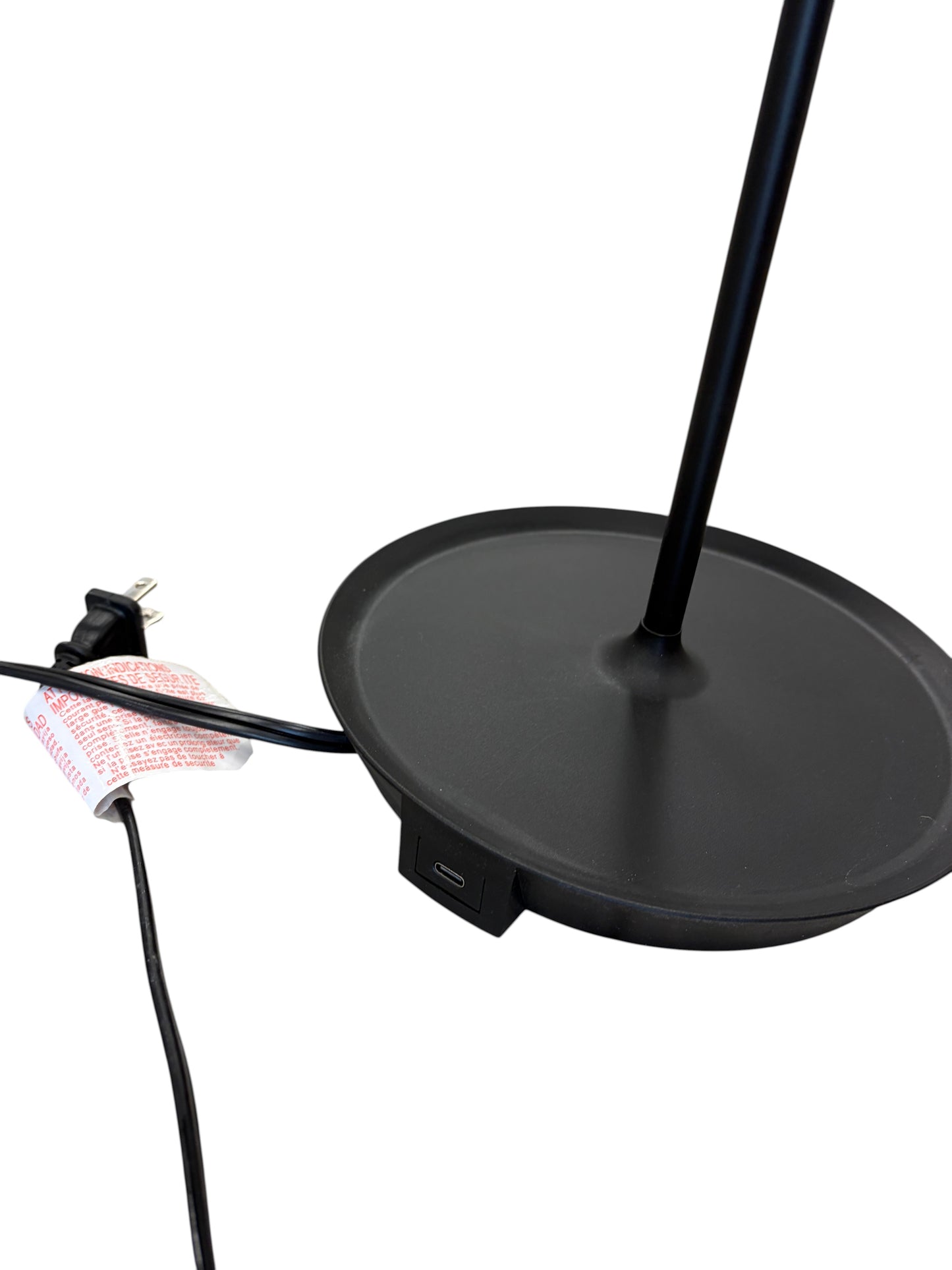 Black table lamp with a charging port.
