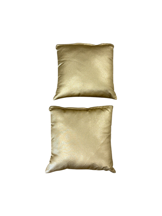 Set of 2 gold throw pillows.