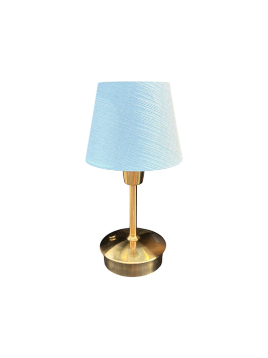 Gold table lamp with a light blue shade.
