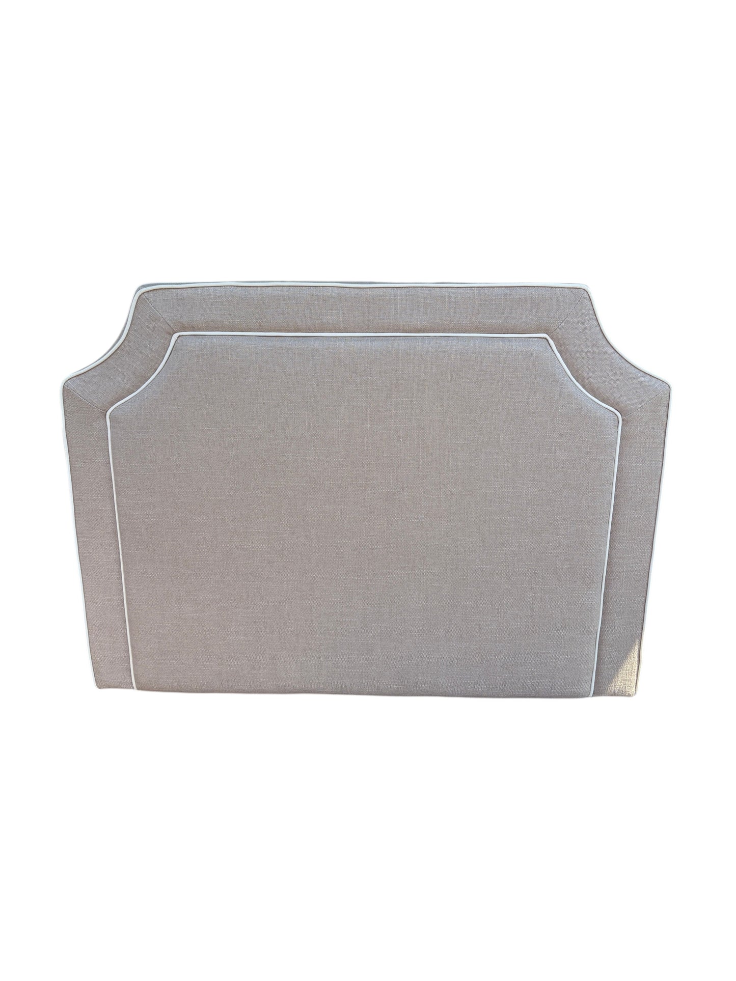 Brown twin headboard with white piping.
