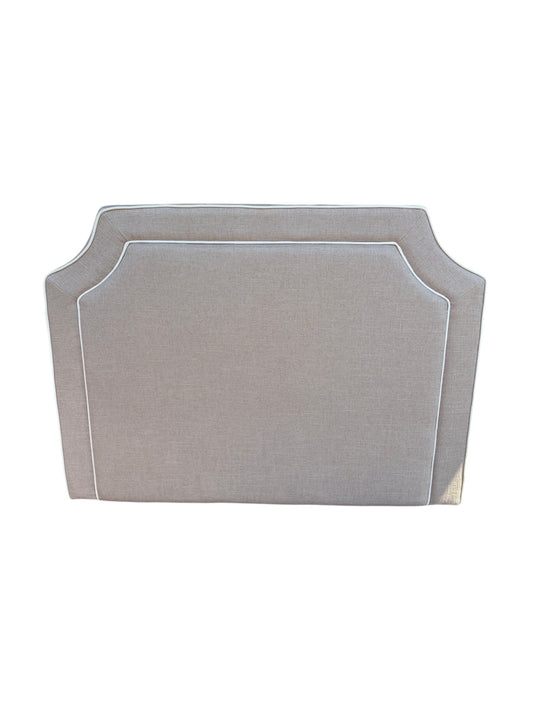 Brown twin headboard with white piping.
