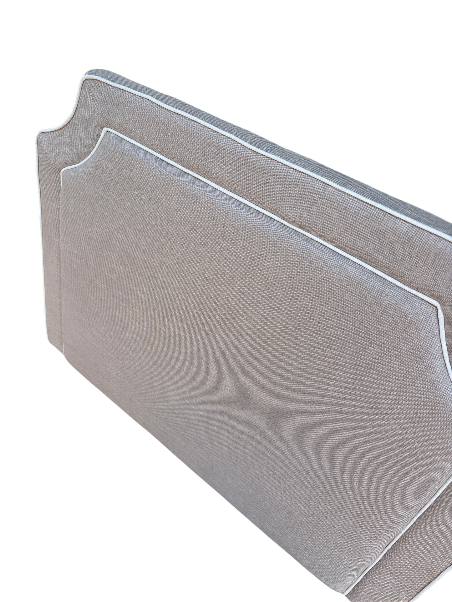 Brown twin headboard with white piping.